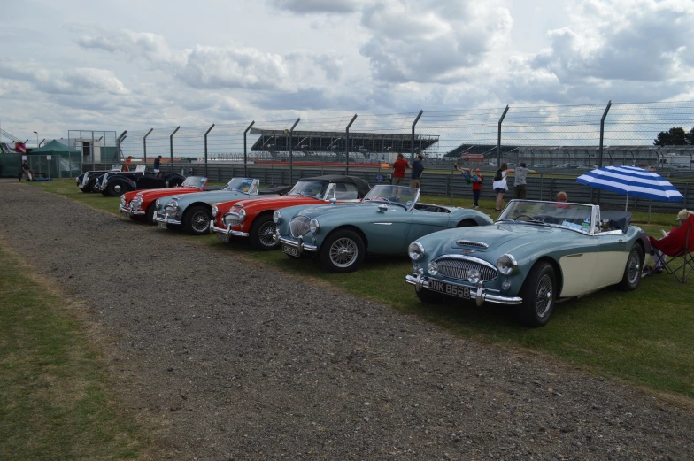 the classic sports cars are parked near each other