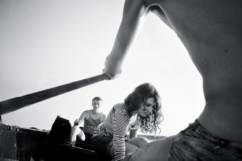 a woman with a baseball bat is sitting on the floor