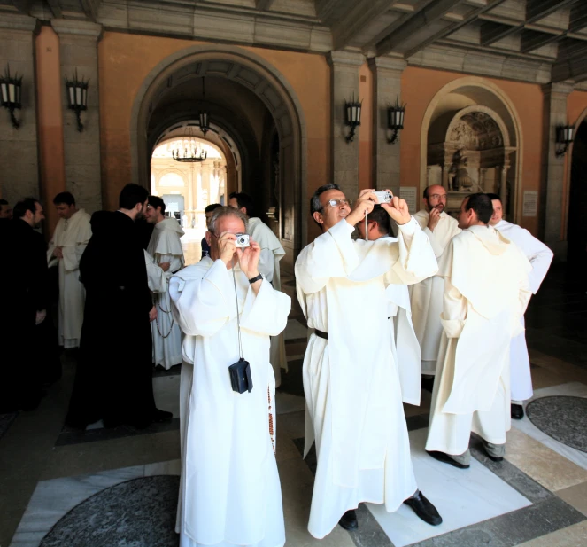 a group of priests standing next to each other in front of a building