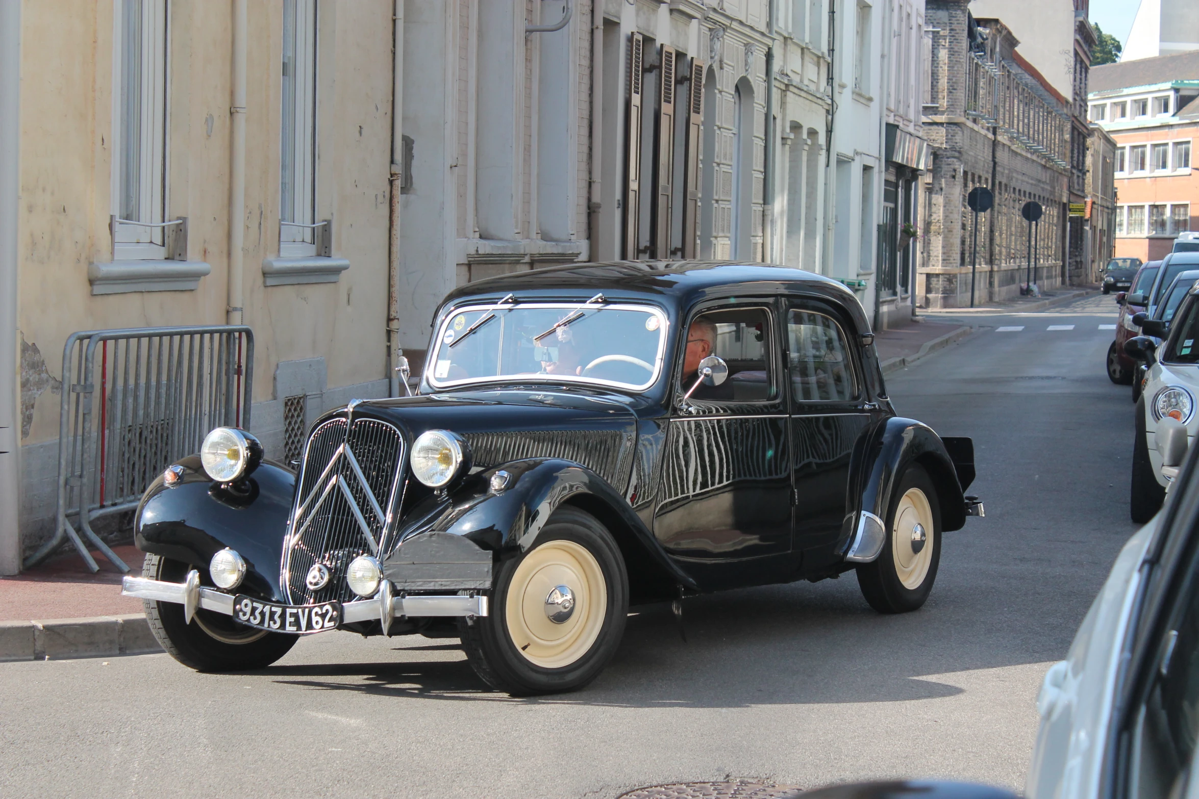 an old car is parked on the street