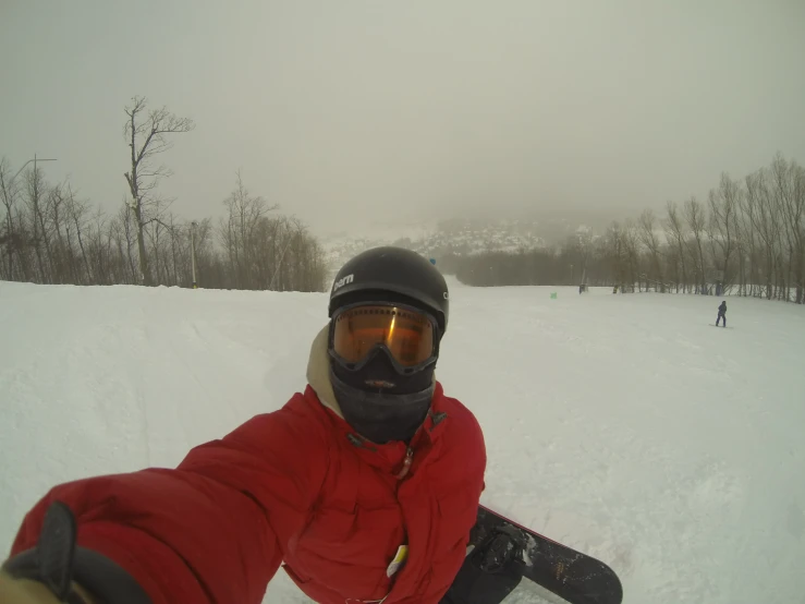 a person sitting in the snow on a ski board