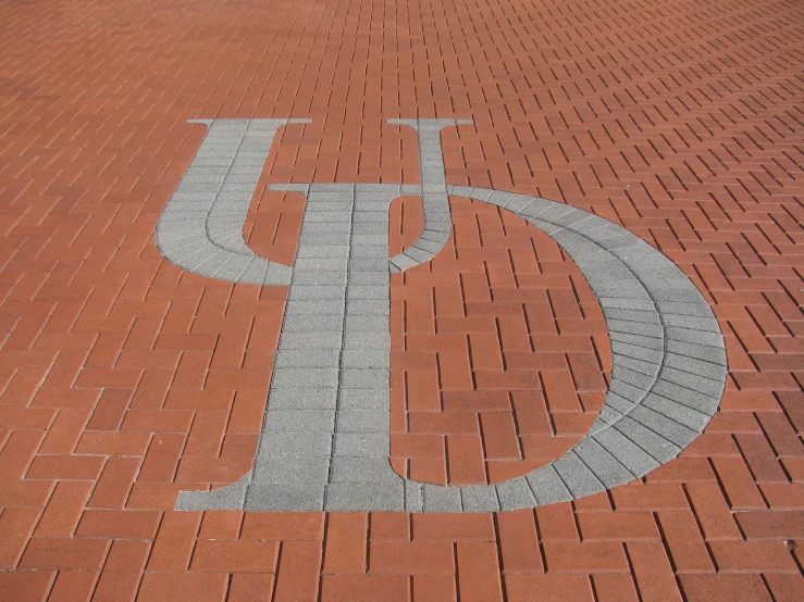 a clock that is sitting on top of red bricks