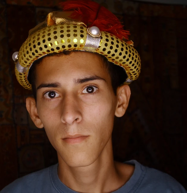 man in yellow dotted hat with red feathers