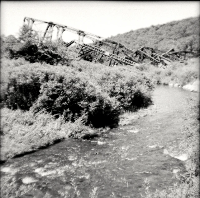 there is an old train track sitting over the river