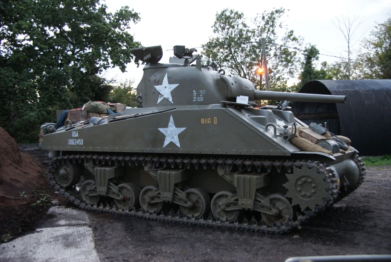 a tank on display with trees in the background