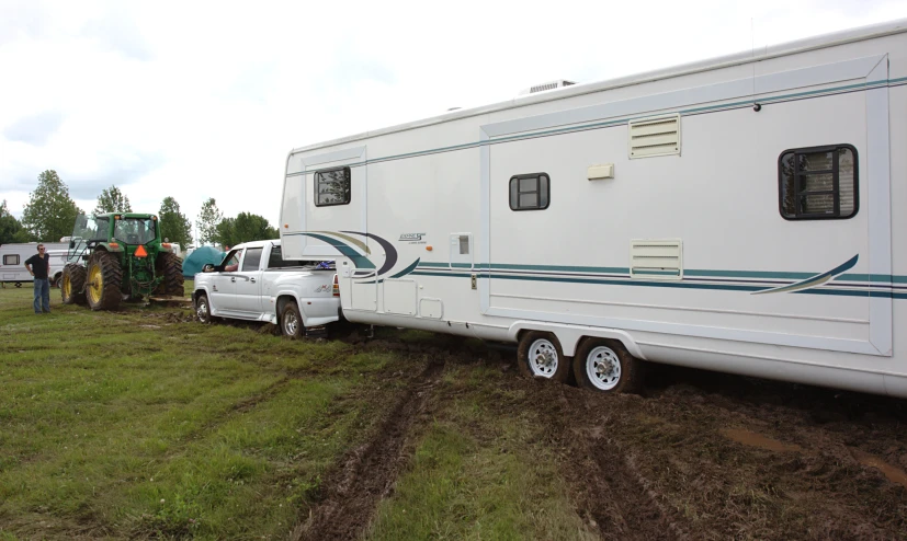 a truck pulling up to a parked trailer