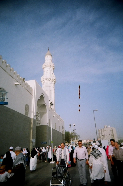 people are walking around in front of a large building