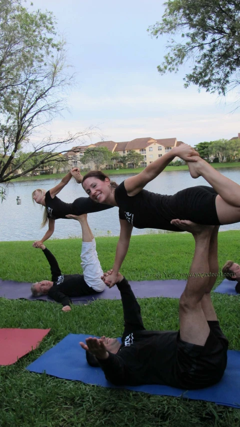 a group of people do yoga together in a park