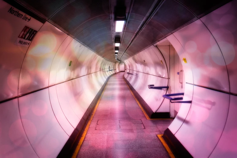 a tunnel leading to the subway station has benches