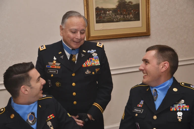 military officers congregate and talk while in conversation