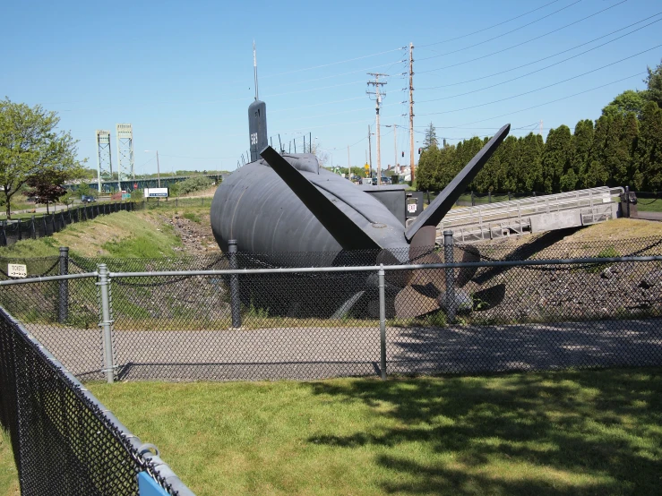 there is a fence surrounding the fence with a large boat on it