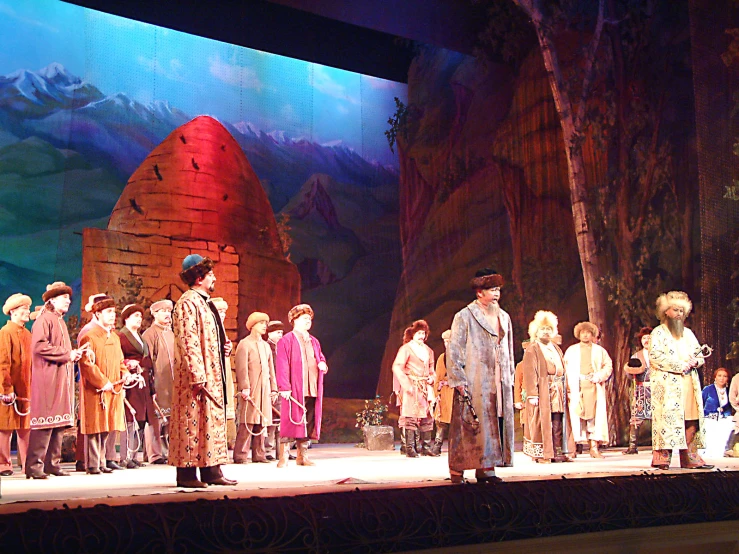 a group of people standing on a stage in front of a castle