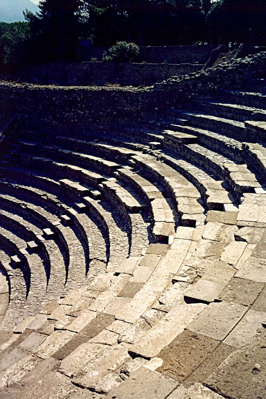 the empty seats of a greek theatre during the daytime