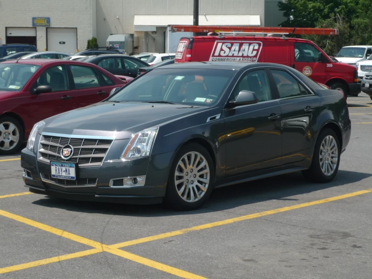 a car parked in a parking lot with other cars behind it