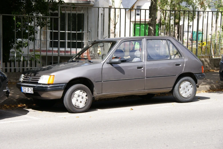 an older car parked on the side of a street