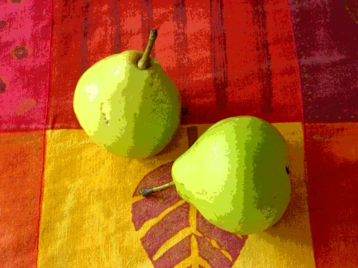 there are two green pears on the towel