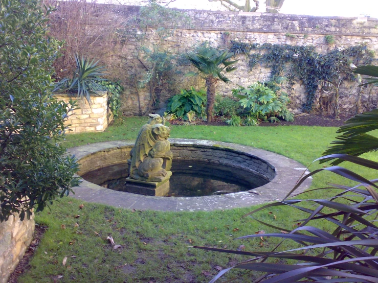small statue in the corner of a round swimming pool