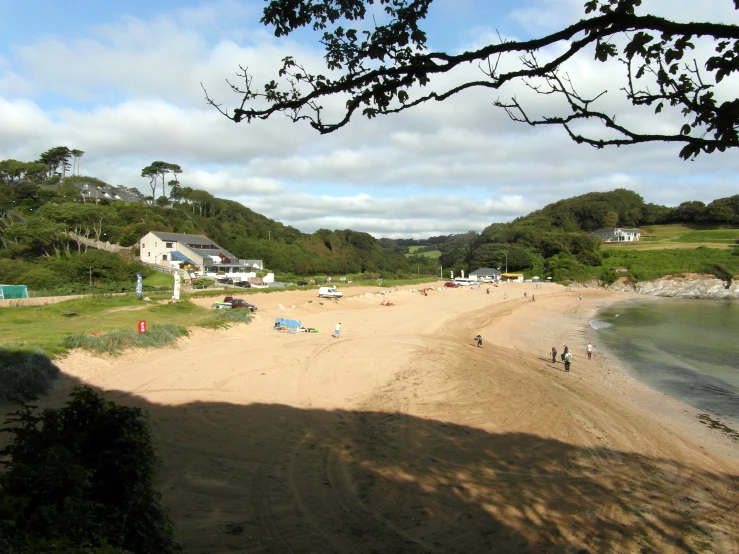 a beach on an overcast day with people walking around