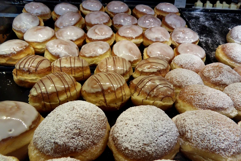 a counter covered with donuts covered in frosting