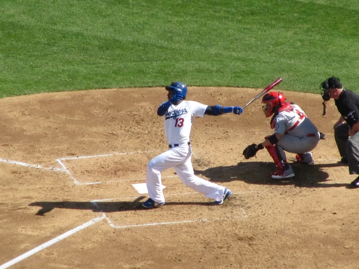 a baseball player swinging a bat while standing on a field