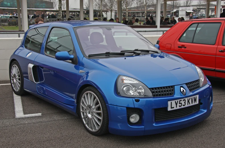 a blue car is parked next to a red car