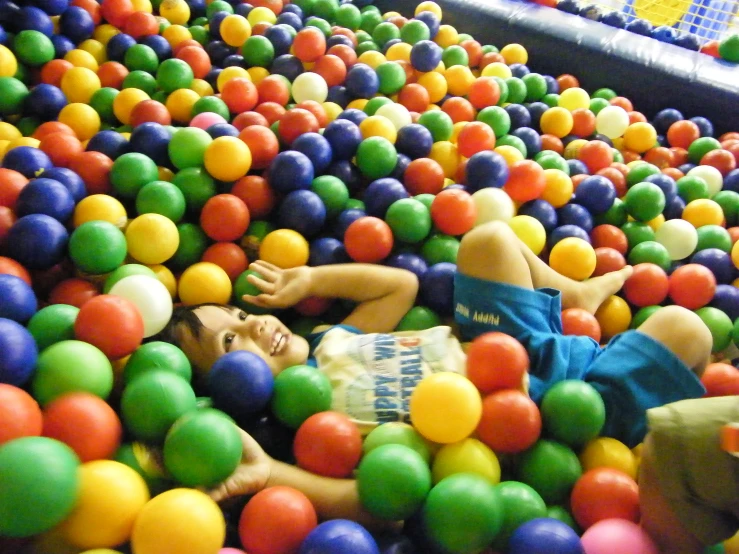 a toy story of the inside of a ball pool with children playing in it