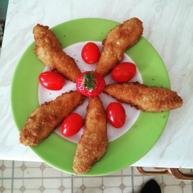 some food on a green plate in the shape of a star
