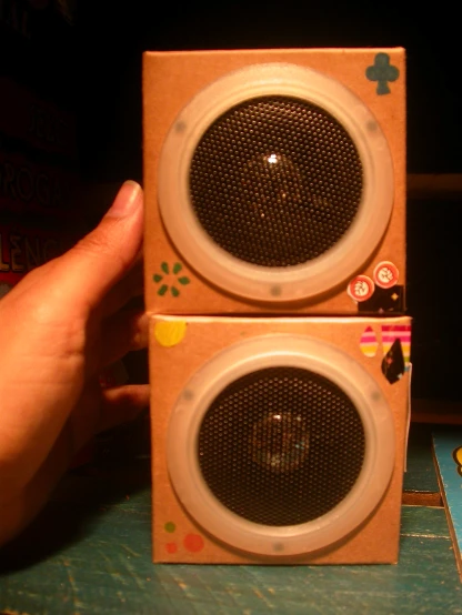 two boxes in the shape of speakers held together