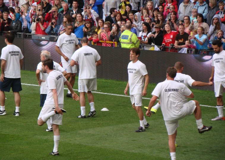 soccer players warming up before the match in the field