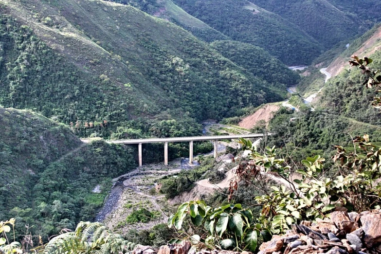 a bridge is over an island in the middle of a mountain