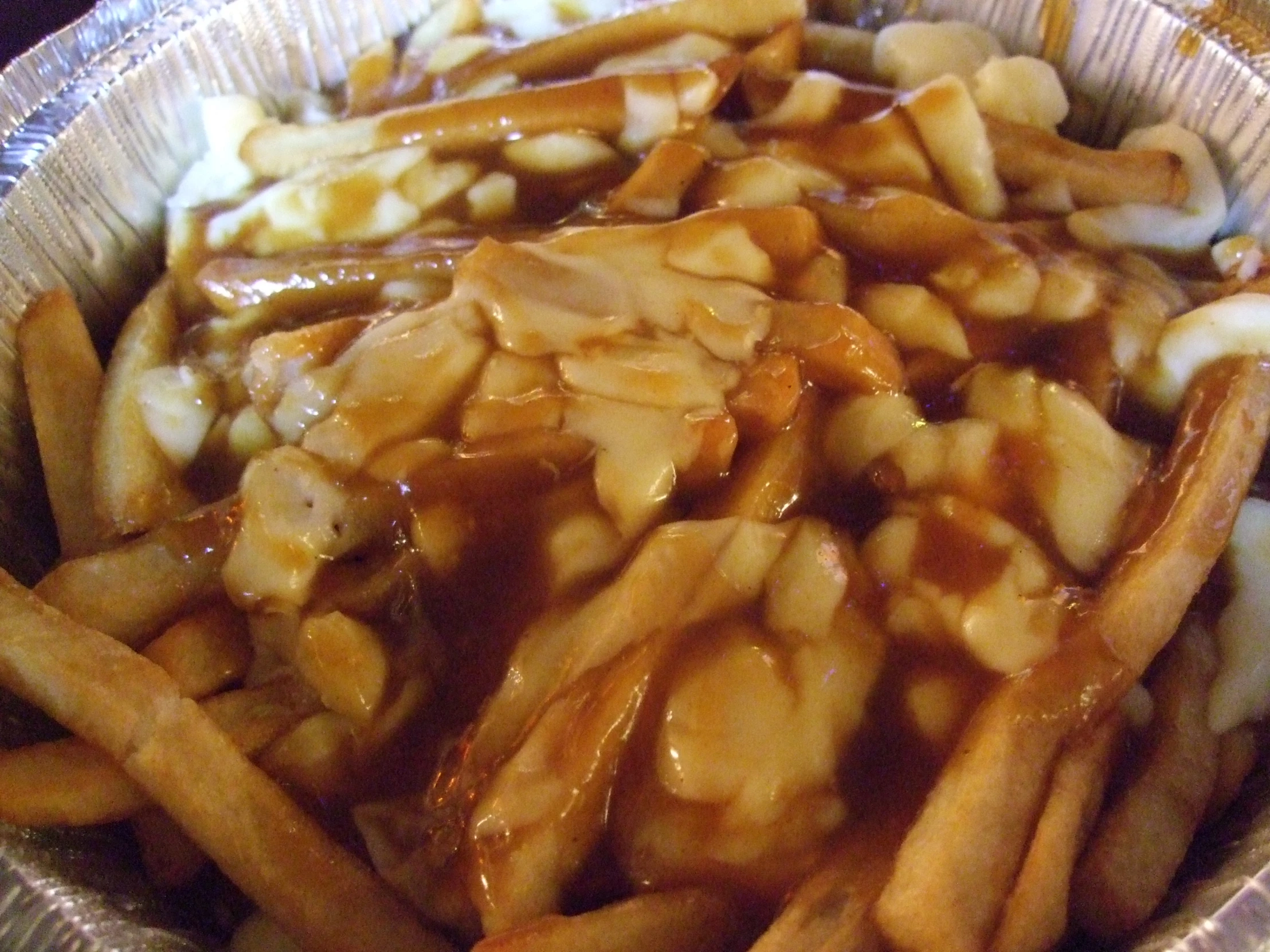 close up image of french fries covered in sauce