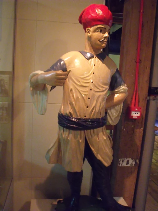 a statue of a baseball player wearing a red helmet