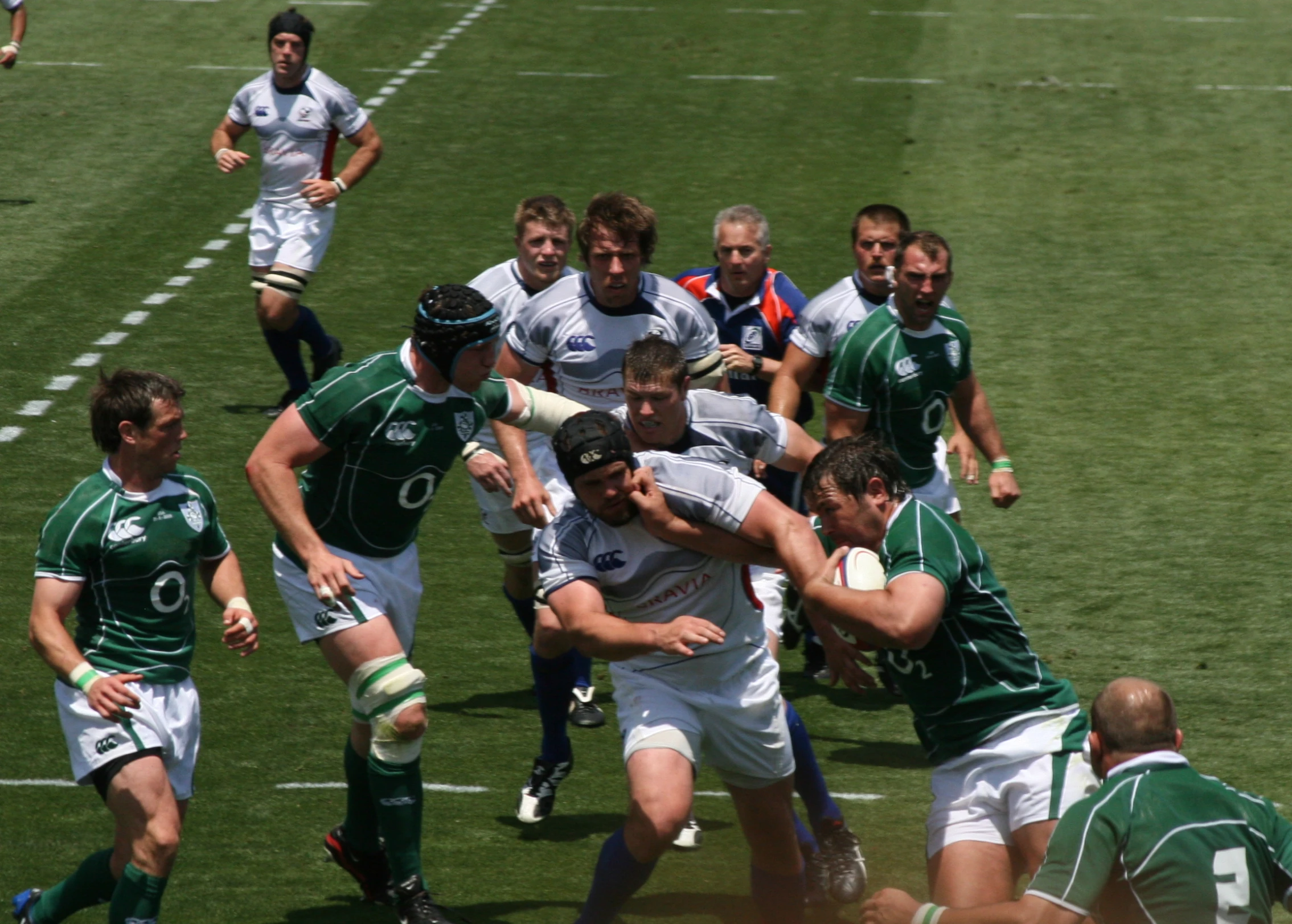 rugby players battle in an inter - enaction on the field