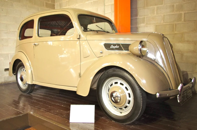 a light brown car is in a display