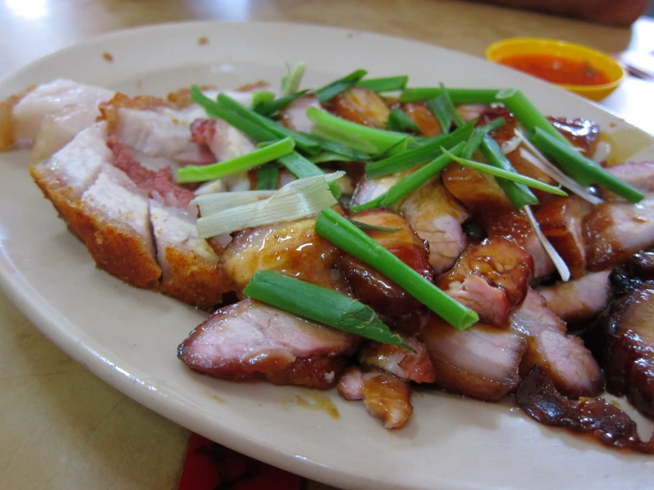 a white plate topped with meat, vegetables and rice