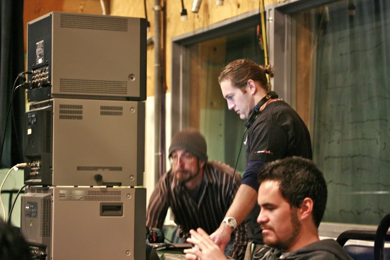 some men are around a table with different equipment