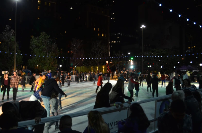 people skate in a rink full of people