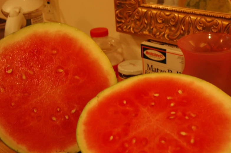 a watermelon sitting on a table with other ingredients