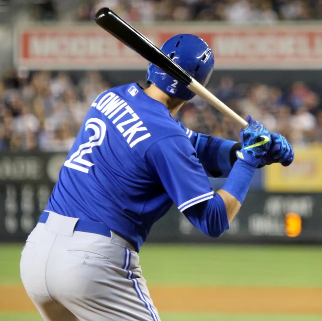 a man in a baseball uniform holding a bat