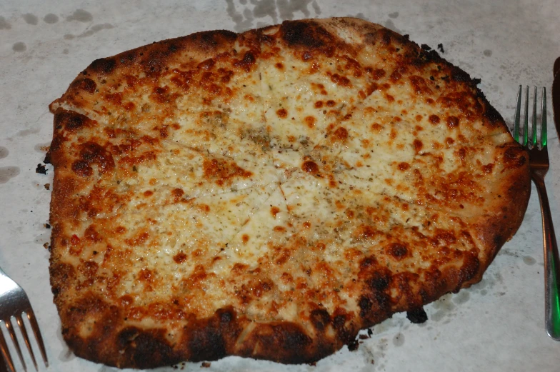 large pizza sitting on top of a white table