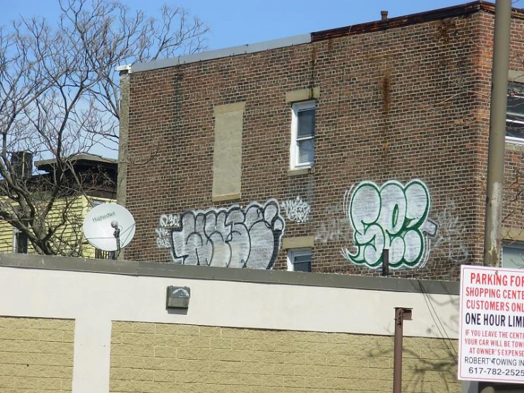 graffiti is spray paint all over a brick building