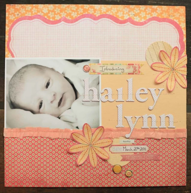 a small scrapbook has the image of a baby holding a yellow flower