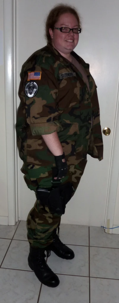 a man in camouflage standing on his knee in a bathroom