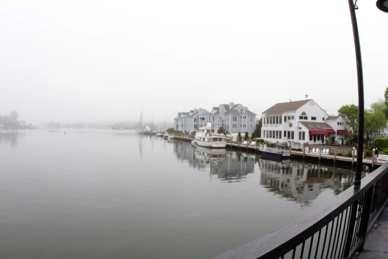 boats in the water along the side of a waterfront town