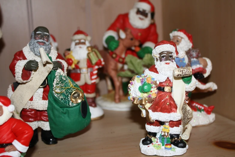 a group of little figurines are all covered in christmas decorations