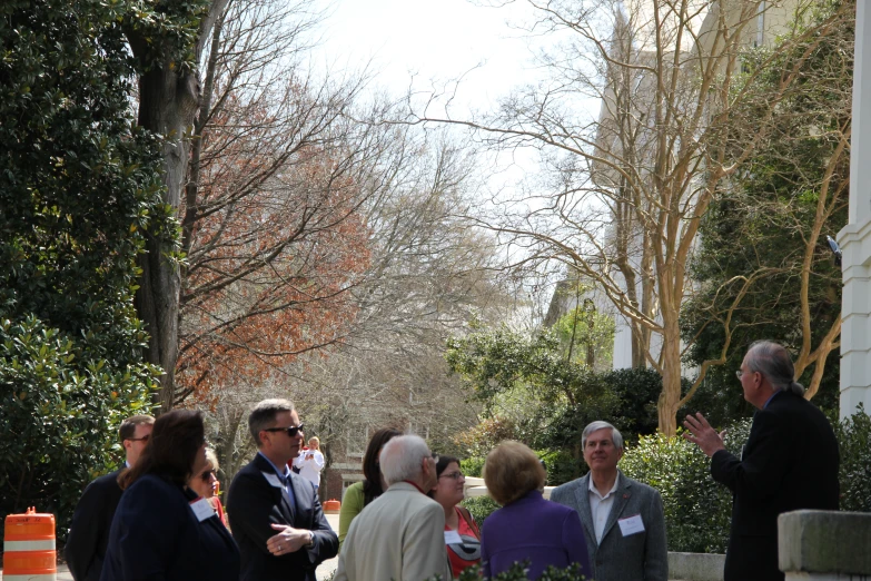 people gathered together outside in the shade