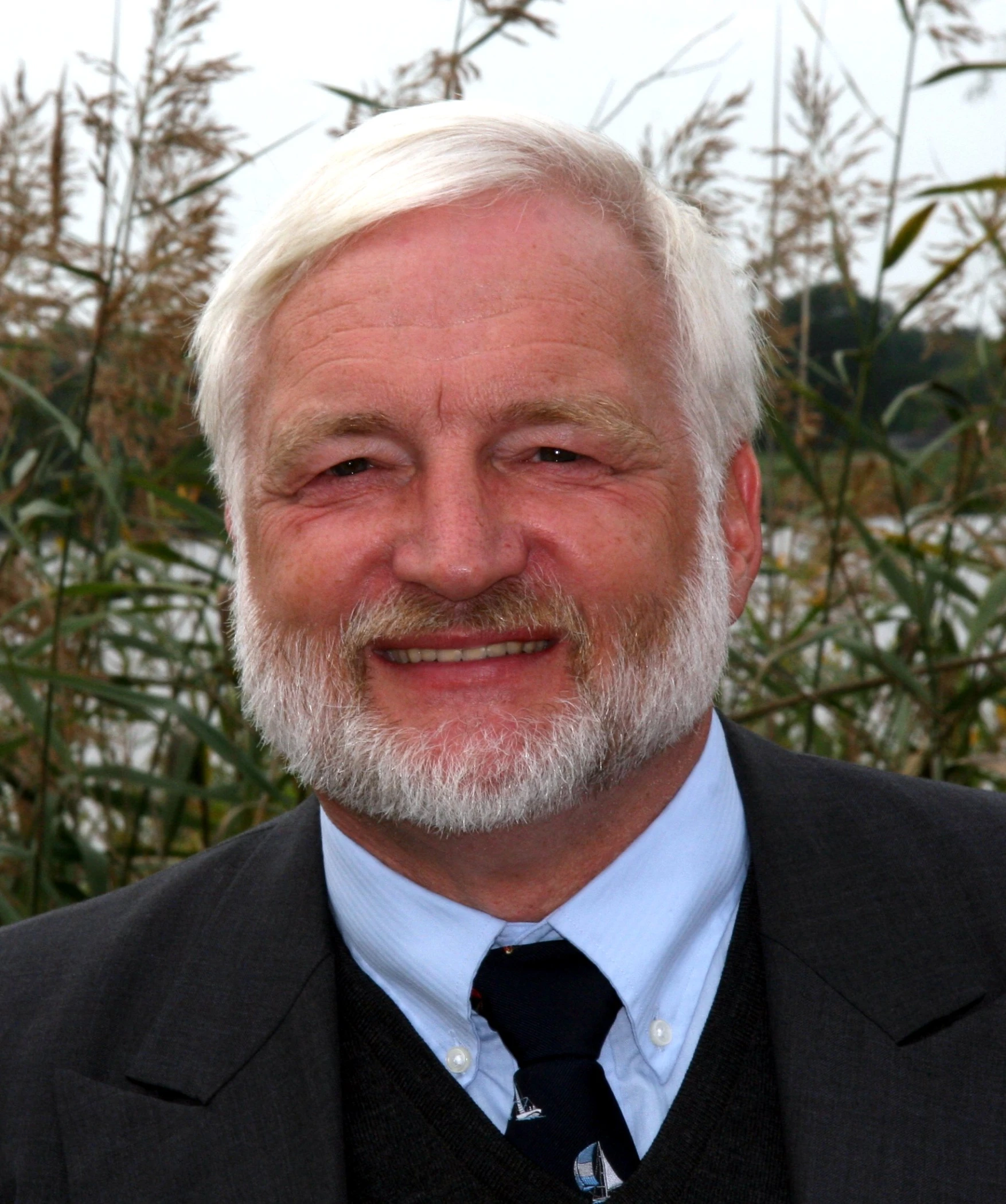 a close up of a person in a suit and tie