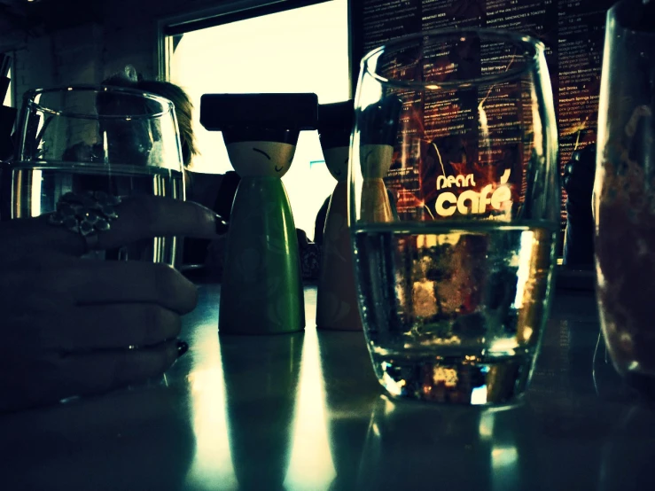 glass with liquid and garnishments on table in restaurant