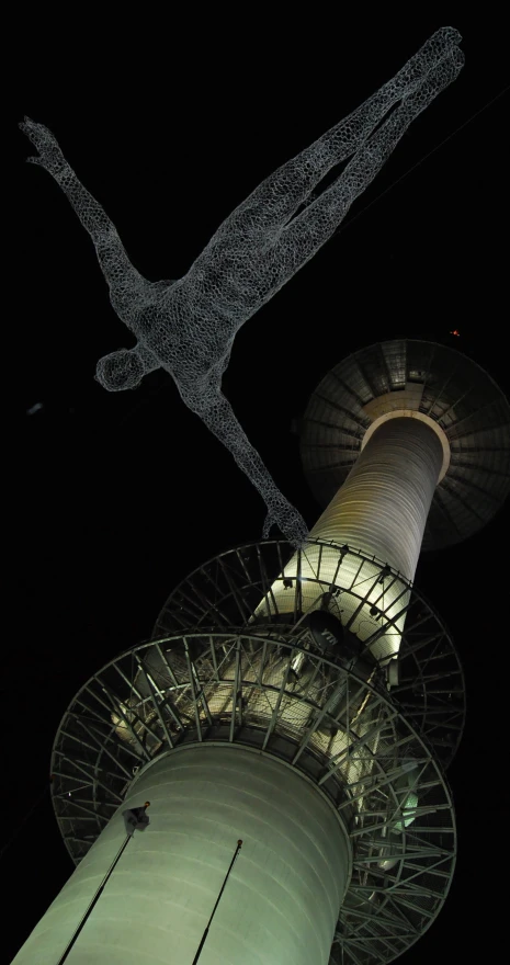 looking up at a tall structure lit up for a display