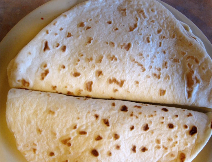 two tortillas sitting on top of a white plate